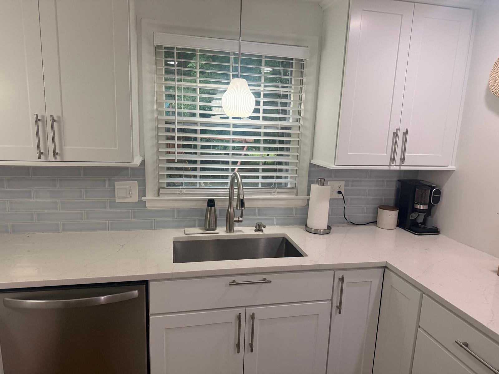 Bright finished kitchen with white cabinets and updated hardware