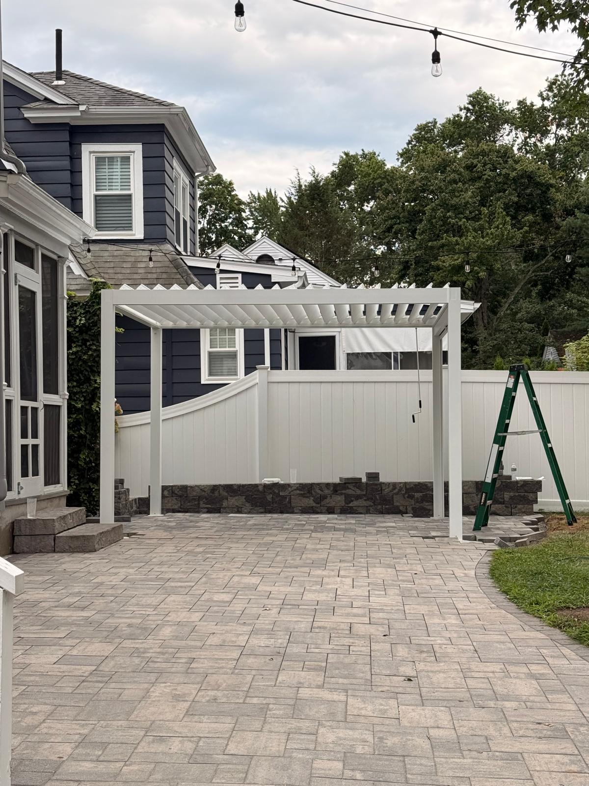 White pergola installed over a residential patio